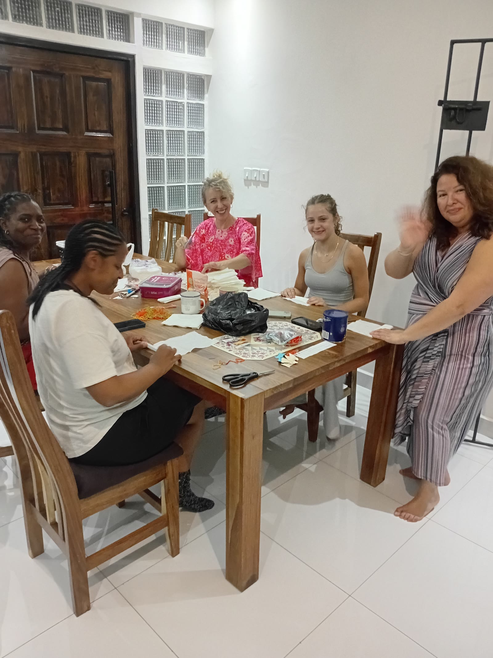 Volunteers smiling around a table indoors